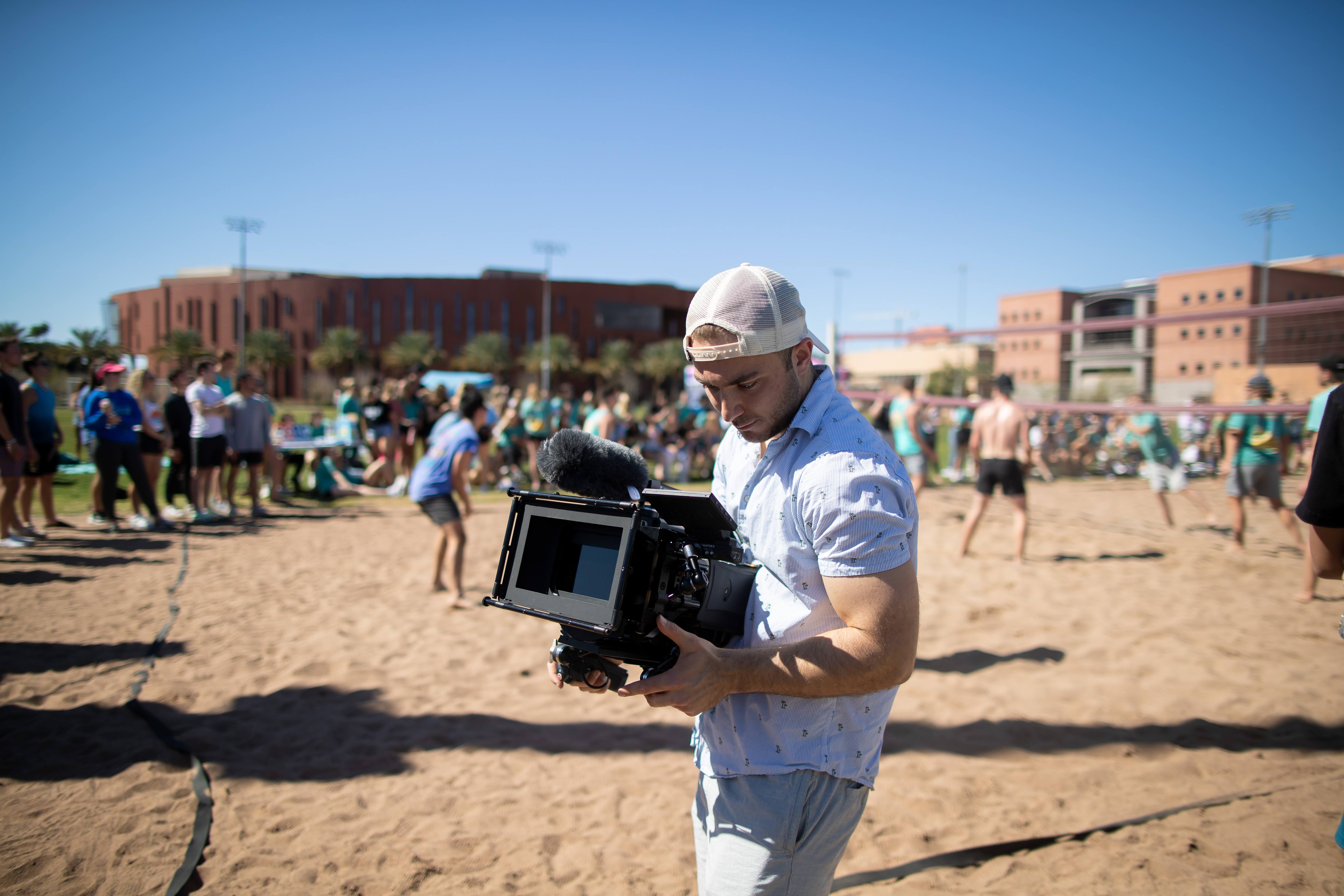 Billy Hardiman filming volleyball match with RED DSMC2 camera at ASU